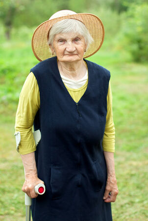 Elderly handicapped woman standing in the gardenの写真素材
