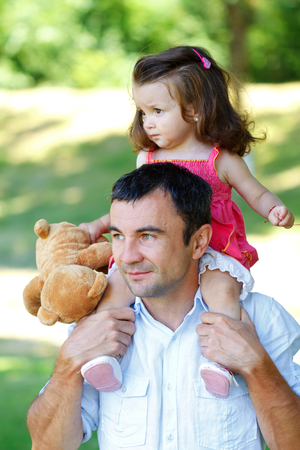 Cheerful father playing with his beautiful daughterの写真素材