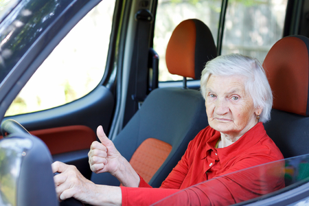 Picture of a confident senior woman driving a car