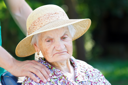 Senior woman in a wheelchair with her caregiverの写真素材