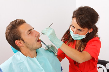 Scared dental patient receiving anesthesia injectionの写真素材