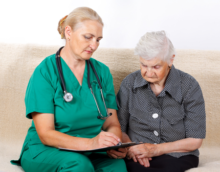 Picture of a senior woman talking with her caregiverの写真素材