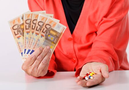 Senior woman paying money for medicationの写真素材