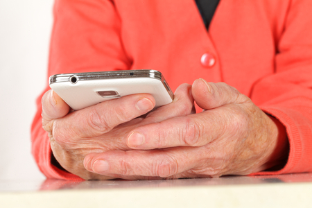 Picture of a  senior woman hand using a smartphoneの写真素材
