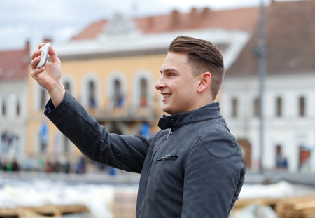 Photo of a handsome and happy  man taking a selfie