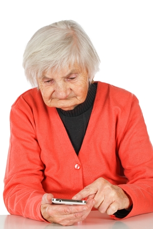 Senior woman using her new white smartphoneの写真素材