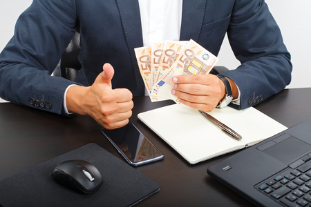 Office manager holding  money in his handsの写真素材
