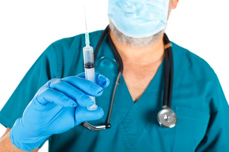Close-up picture of a surgeon holding a syringe on a isolated backgroundの写真素材