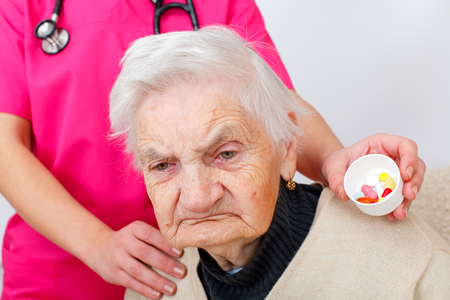 Picture of a disabled senior woman with her caregiverの写真素材