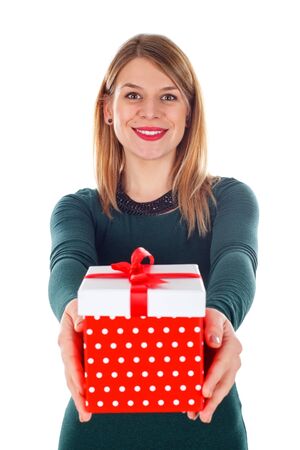 Portrait of a beautiful young woman holding a christmas gift on an isolated backgroundの写真素材