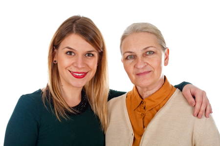 Portrait of two beautiful ladies: mother-daughter on an isolated backgroundの写真素材