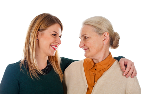 Portrait of two beautiful ladies: mother-daughter on an isolated backgroundの写真素材