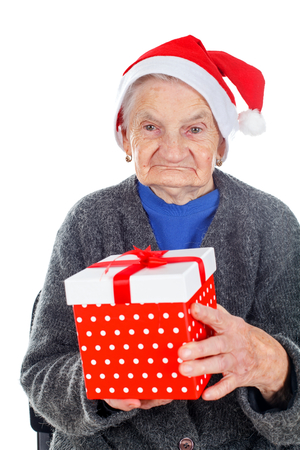 Picture of an elderly woman holding a Christmas giftの写真素材