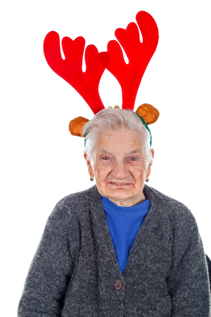 Portrait of an old woman wearing a reindeer slide on an isolated backgroundの写真素材