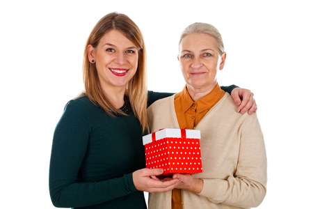 Picture of a beautiful young girl spending Christmas-time with her motherの写真素材
