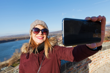Picture of a smiling young tourist taking a selfie in Esztergom, Hungaryの写真素材