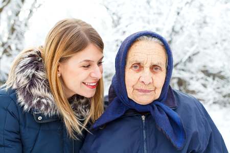 Portrait of a young woman with her happy grandmotherの写真素材