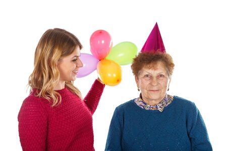 Picture of an eldery woman celebrating birthday with her granddaughterの写真素材