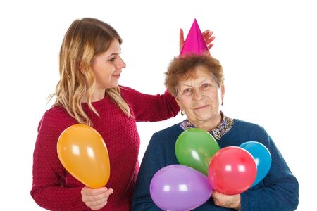 Picture of a senior lady celebrating birthday with her granddaughterの写真素材