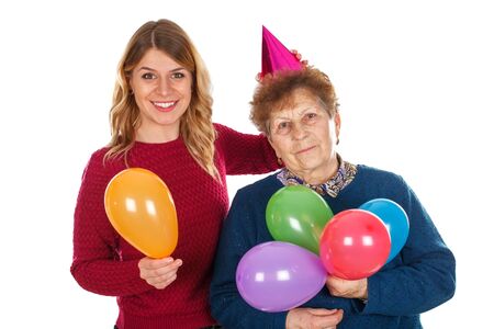 Picture of a senior lady celebrating birthday with her granddaughterの写真素材