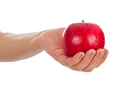 Picture of a fresh red apple held by a young womanの写真素材