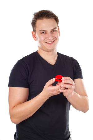 Picture of a sexy young man holding a proposal ring - isolated backgroundの写真素材
