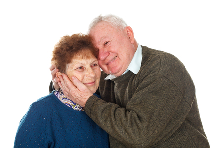 Picture of an old couple hugging each other - isolated backgroundの写真素材