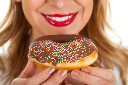 Close up picture of a sexy woman eating a doughnutの写真素材
