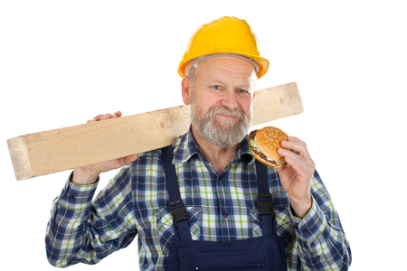 Picture of an engineer having a burger while workingの写真素材