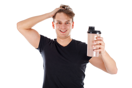 Picture of an attractive young man holding a protein shakeの写真素材