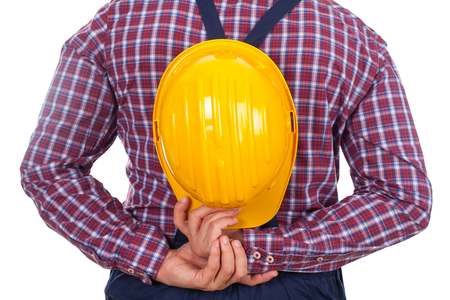 Close up picture of an engineer's back, holding his helmetの写真素材