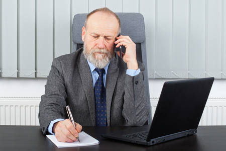 Picture of a thoughtful employer having a phone callの写真素材