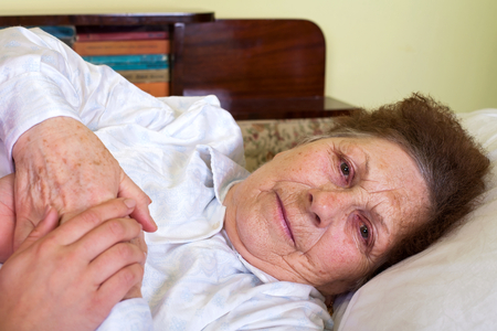 Picture of a bedridden elderly woman at homeの写真素材