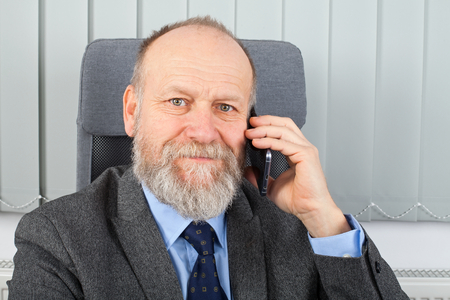 Portrait of a smiling businessman talking on the phoneの写真素材