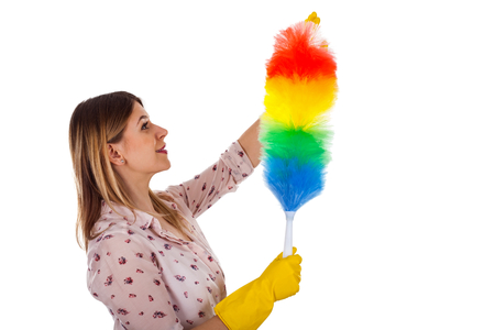 Portrait of an attractive female housekeeper holding a house flannel on isolated backgroundの写真素材