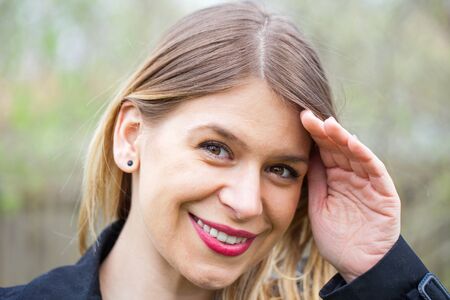 Portrait of an attractive young woman outdoor in blooming garden, springtimeの写真素材
