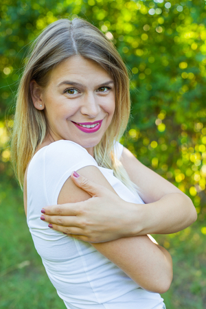 Portrait of sexy young woman smiling back at the camera posing outdoorの写真素材