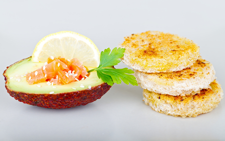 Picture of a tasty breakfast with avocado, smoked salmon and toast on isolated backgroundの写真素材