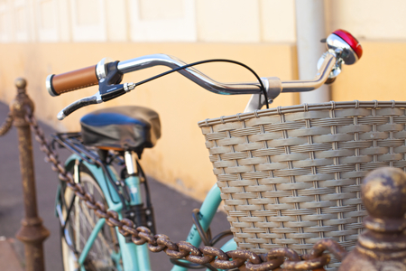 Close up picture of vintage bike with shopping basket parked on a sideway in Hungary, Europeの写真素材