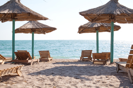 Picture of sunbeds and umbrellas on the romania seaside in Vama Veche, Romaniaの写真素材