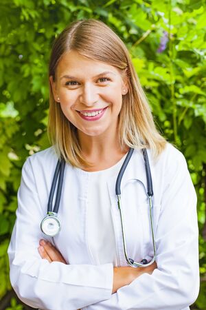 Portrait of a confident female doctor smiling at the camera outdoorの写真素材