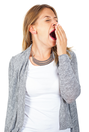 Picture of tired woman yawning on isolated backgroundの写真素材