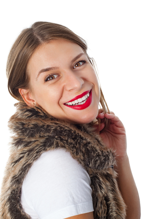 Attractive young woman wearing red lipstick and fur jacket on isolated backgroundの写真素材