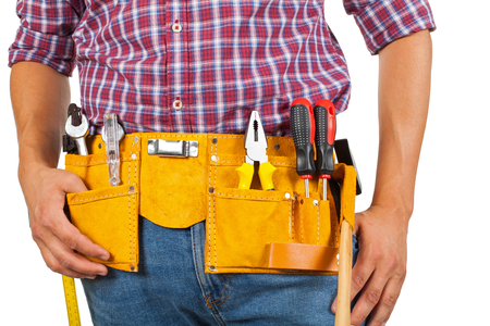 Close up picture of young handyman's yellow tool belt on isolated backgroundの写真素材