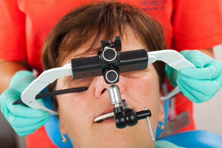 Seniorpatient wearing a  facebow for transfer functional and aesthetic components from patient's...