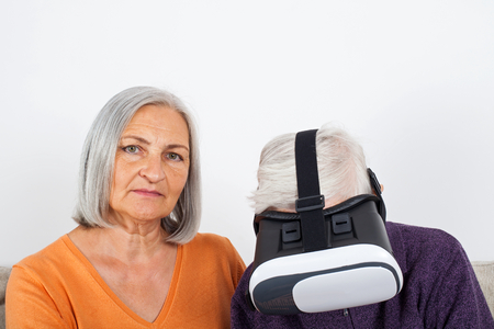 Elderly women experiencing virtual reality video with headsetの写真素材