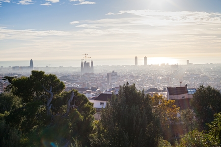Morning panorama of Barcelona taken from Park GÃ¼ell - rooftops, historical buildings, beautiful sunny weatherの写真素材