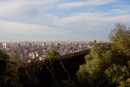 Morning panorama of Barcelona taken from Park GÃ¼ell - rooftops, historical buildings, beautiful sunny weatherの写真素材