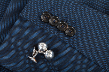 Close up picture of mens suit sleeve and silver cufflinks