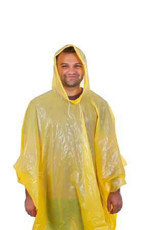 Picture of a caucasian young man wearing a yellow raincoat, posing on isolated backgroundの写真素材